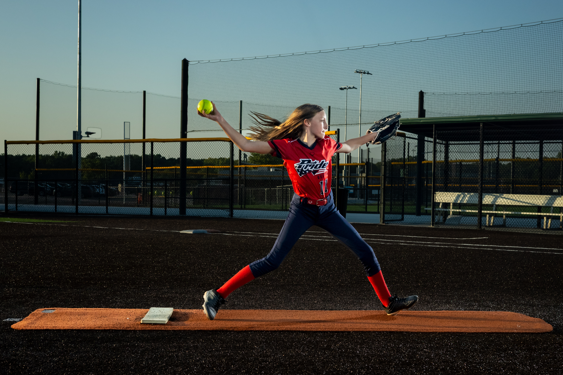 Pride Fastpitch pitcher delivering a pitch from the mound